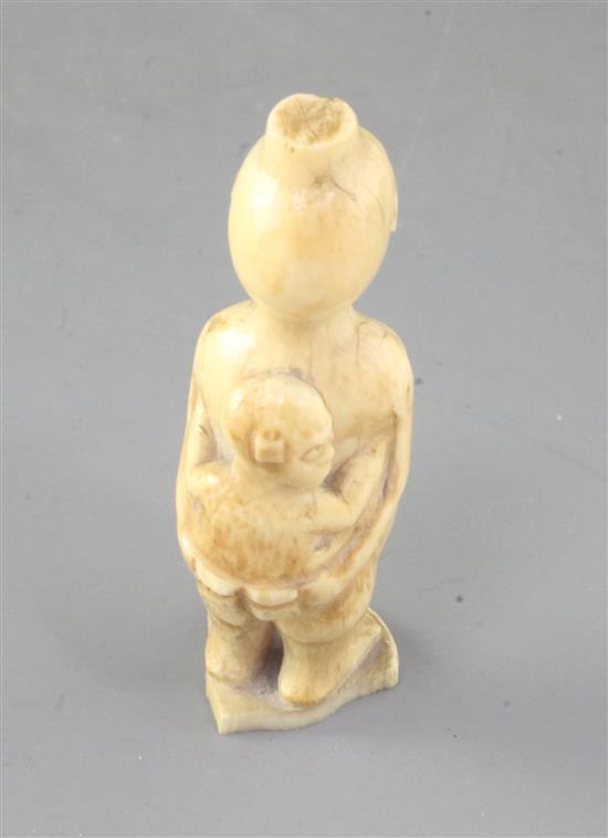 A 19th century African ivory group of a mother and child, height 3.25in.